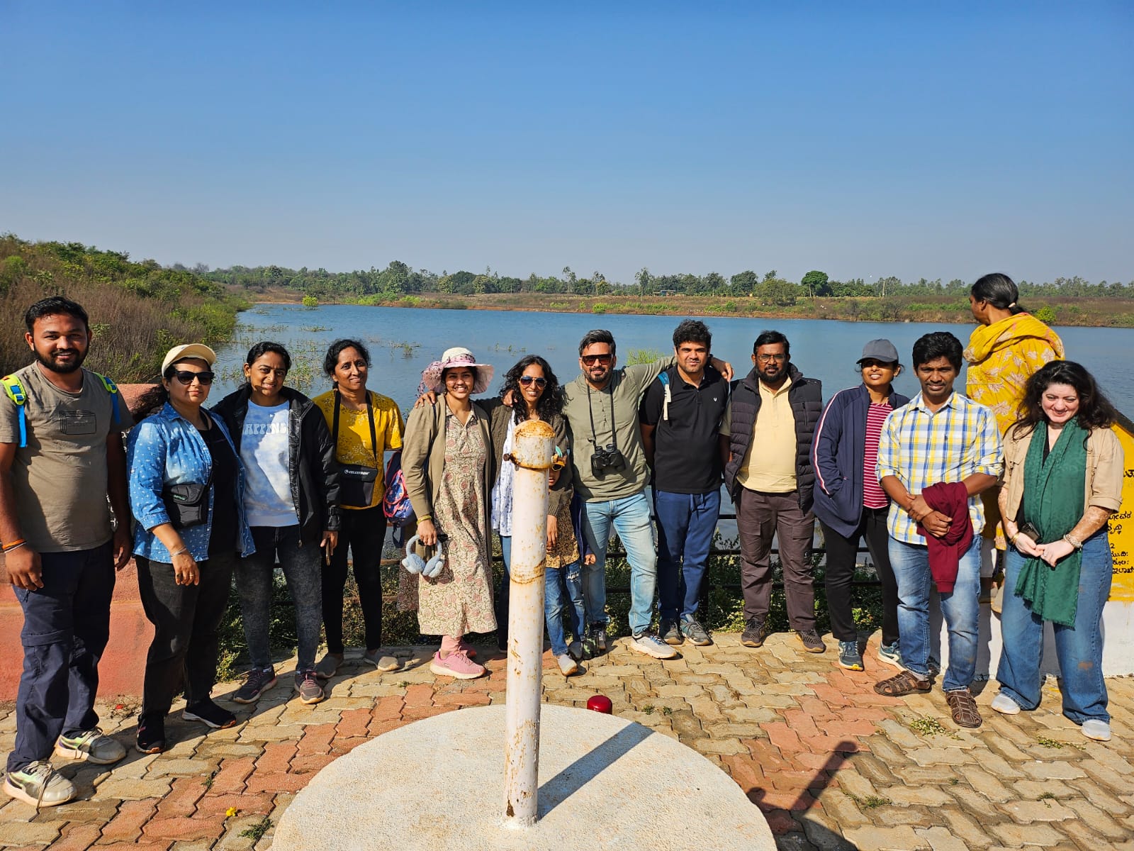 A group gathered beside a lake